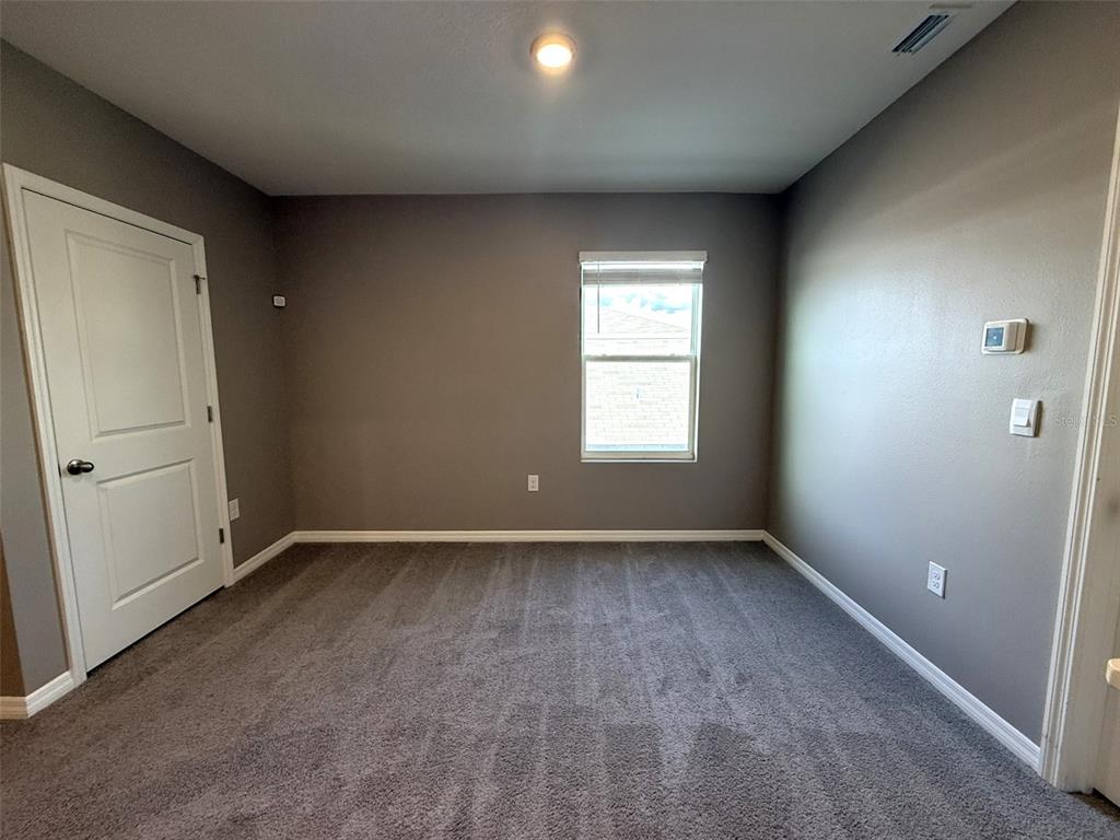 8446 Hardy Bay Loop Wesley Chapel, FL 33545 - Photo 24 of 38 an empty room with windows