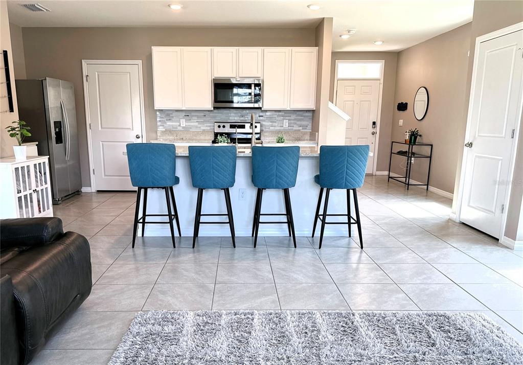 8446 Hardy Bay Loop Wesley Chapel, FL 33545 - Photo 3 of 38 a view of a dining room with furniture