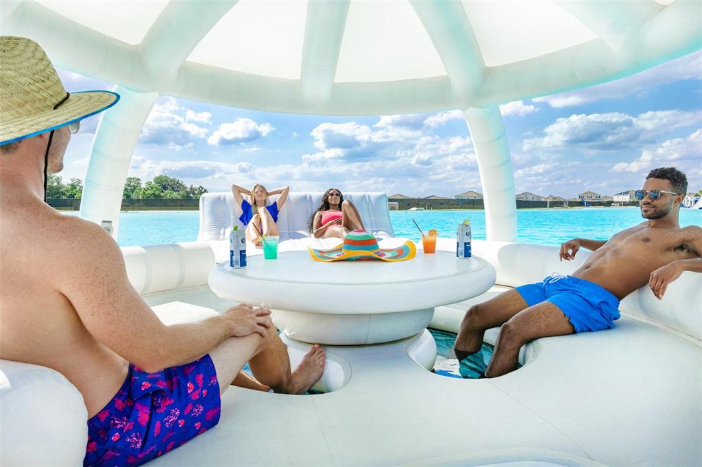 8446 Hardy Bay Loop Wesley Chapel, FL 33545 - Photo 32 of 38 a living room with furniture and a floor to ceiling window