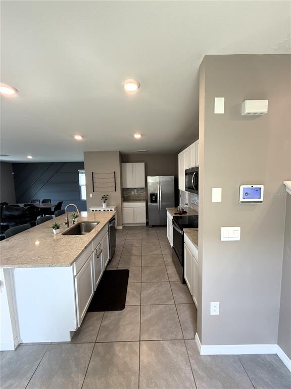 8446 Hardy Bay Loop Wesley Chapel, FL 33545 - Photo 5 of 38 a large kitchen with stainless steel appliances lots of counter space