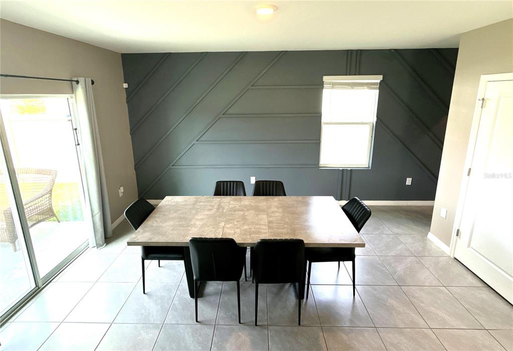 8446 Hardy Bay Loop Wesley Chapel, FL 33545 - Photo 10 of 38 a dining room with a table and chairs