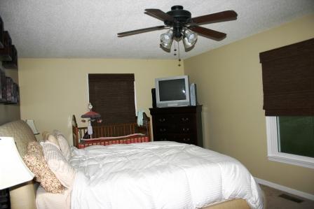 547 Smith Road Bell Buckle, TN 37020 - Photo 17 of 20 a bedroom with a bed and a flat tv screen on the dresser