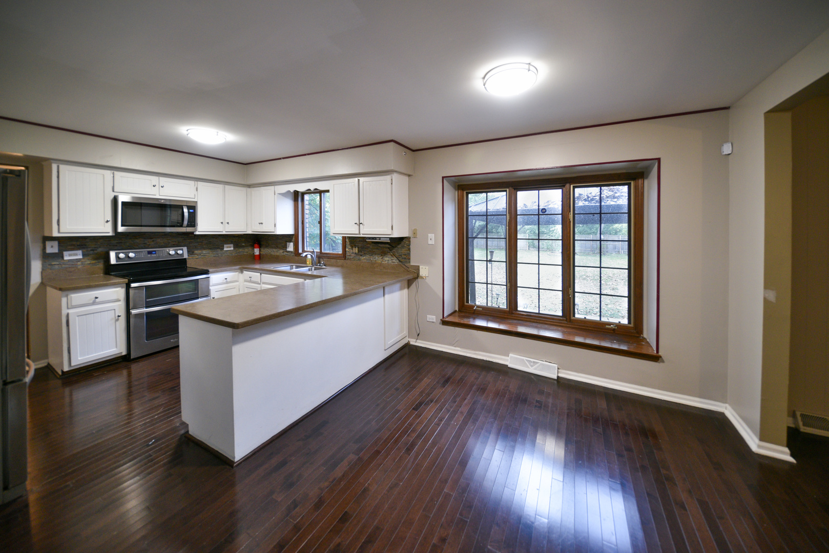 755 Cumnock Road Olympia Fields, IL 60461 - Photo 12 of 34 a kitchen with a stove a sink and a microwave