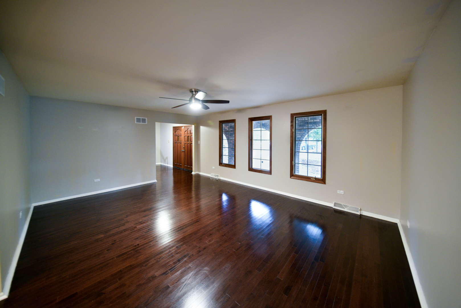 755 Cumnock Road Olympia Fields, IL 60461 - Photo 2 of 34 an empty room with wooden floor and windows