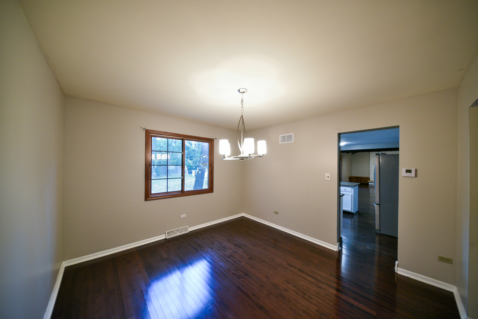 755 Cumnock Road Olympia Fields, IL 60461 - Photo 6 of 34 an empty room with wooden floor and windows