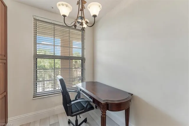 a view of a dining room with furniture wooden floor and chandelier