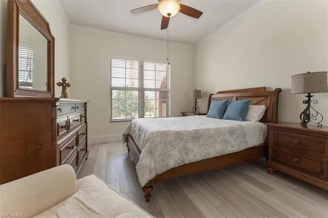 a bedroom with a bed lamps and window