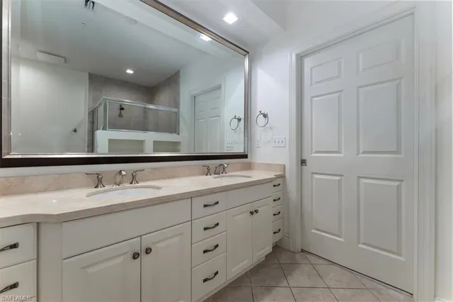 a bathroom with a double vanity sink and mirror