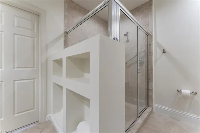 a bathroom with a shower and a glass door