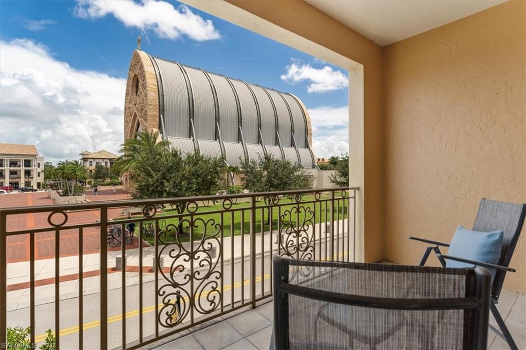 5080 Annunciation Circle, Unit 204 Ave Maria, FL 34142 - Photo 22 of 24 a view of a chair and table in the balcony