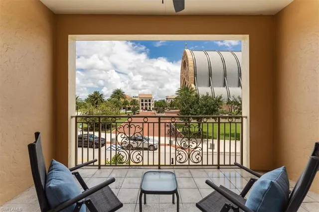 a balcony with table and chairs