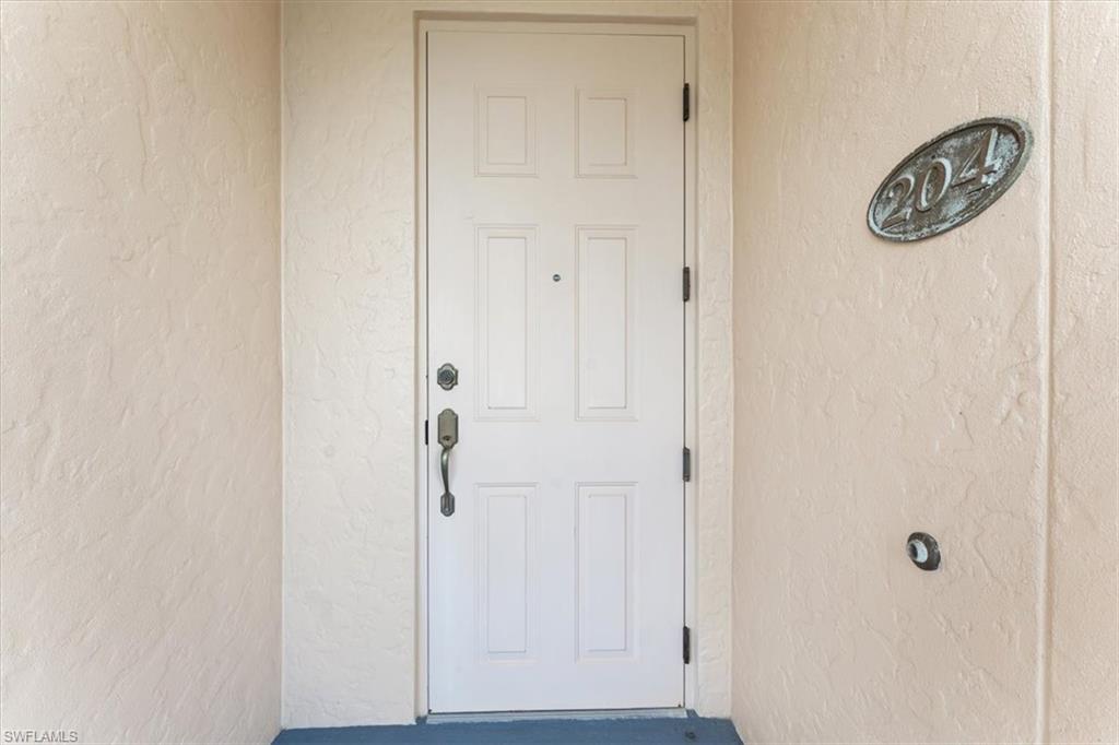 5080 Annunciation Circle, Unit 204 Ave Maria, FL 34142 - Photo 3 of 24 a view of a hallway with a elevator