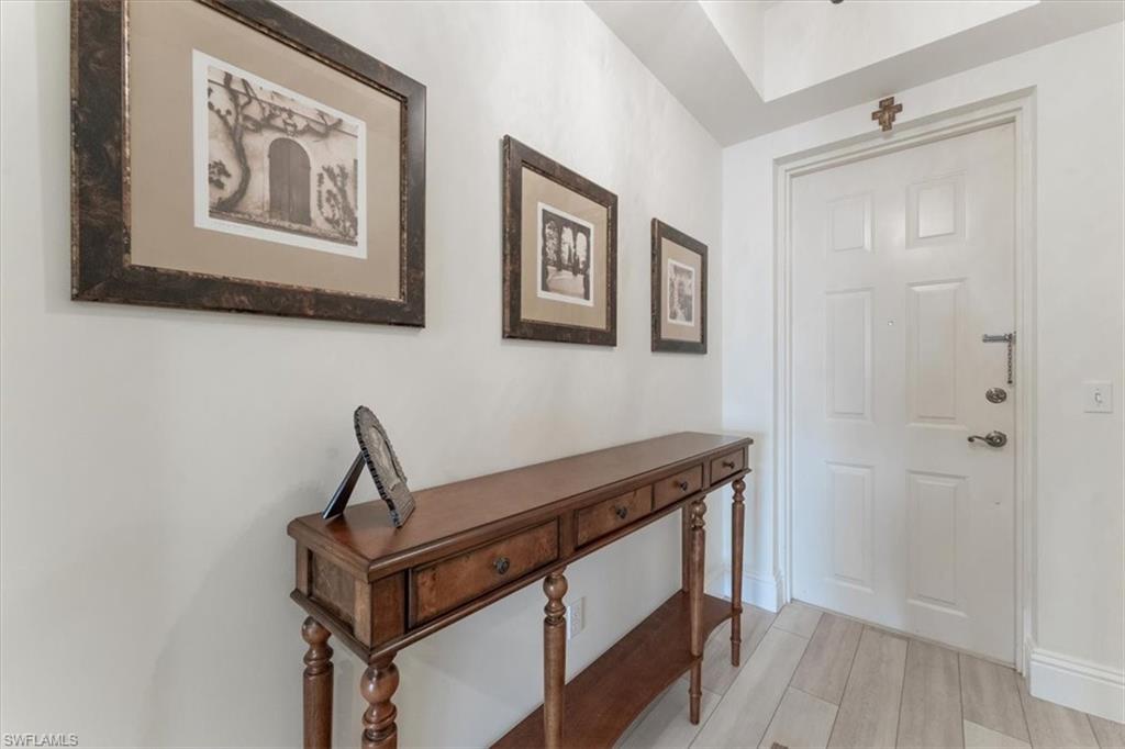5080 Annunciation Circle, Unit 204 Ave Maria, FL 34142 - Photo 4 of 24 a view of an entryway with wooden floor