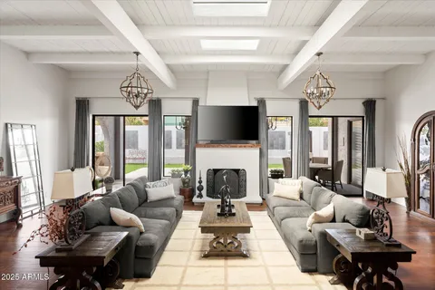 a living room with furniture fireplace and a large window