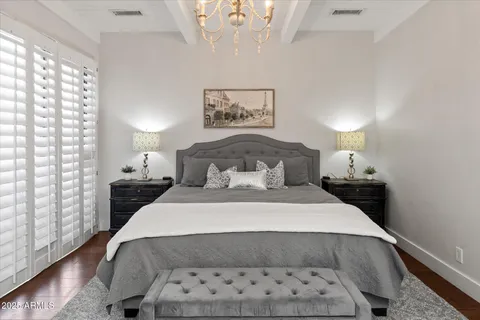 a bedroom with a bed and a painting on the wall