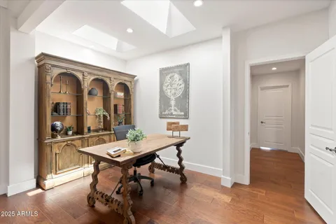 a living room with furniture a table and wooden floor
