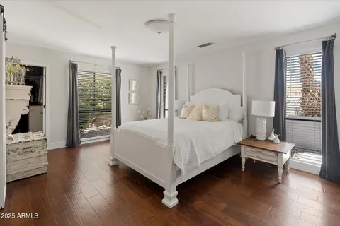 a bedroom with a bed and large window