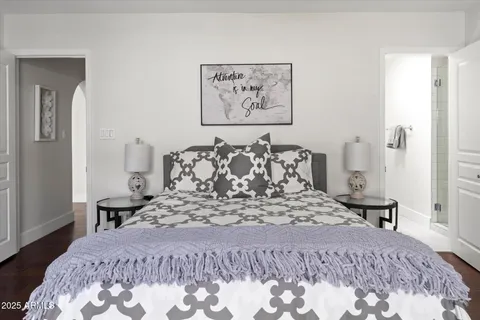 a large bed sitting in a bedroom and a table