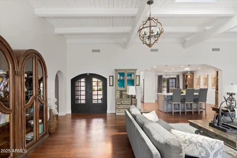 a view of a room with furniture and wooden floor