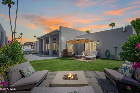 a view of a patio with couches table and chairs and potted plants