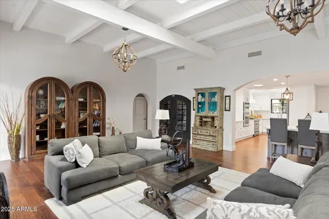 a living room with furniture a rug and white walls