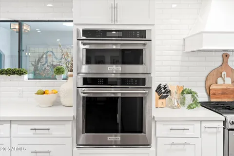 a stove top oven sitting inside of a kitchen
