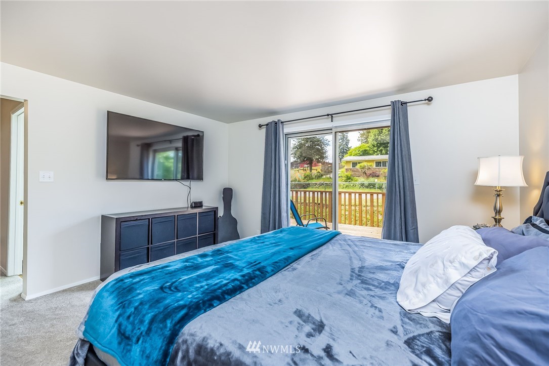 16204 Southeast 132nd Street Renton, WA 98059 - Photo 11 of 38 a bedroom with a large bed and a window