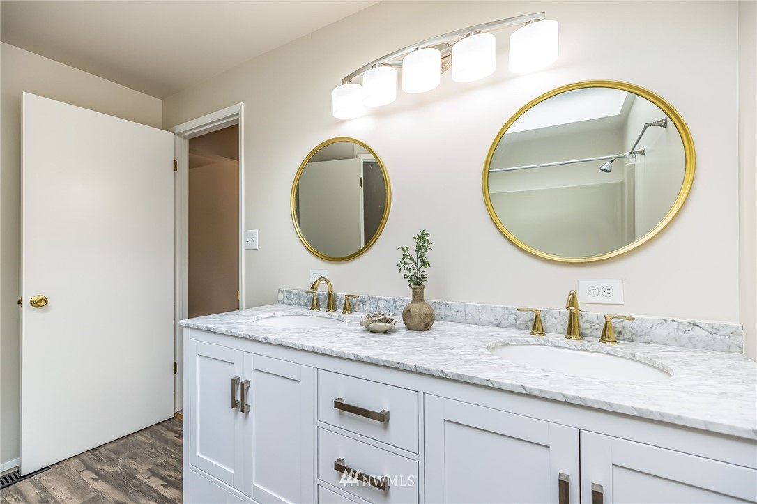 16204 Southeast 132nd Street Renton, WA 98059 - Photo 14 of 38 a bathroom with a granite countertop double vanity sinks and a mirror