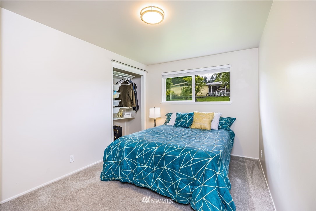 16204 Southeast 132nd Street Renton, WA 98059 - Photo 17 of 38 a bed sitting in a bedroom next to a window