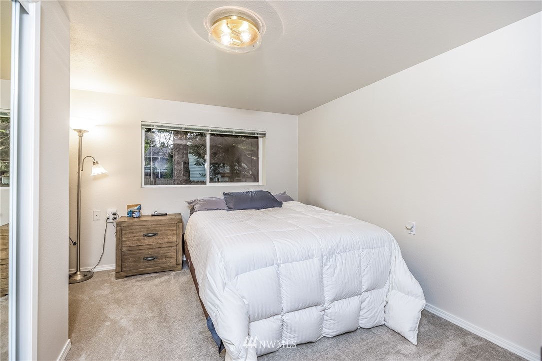 16204 Southeast 132nd Street Renton, WA 98059 - Photo 25 of 38 a bedroom with a bed and a dresser