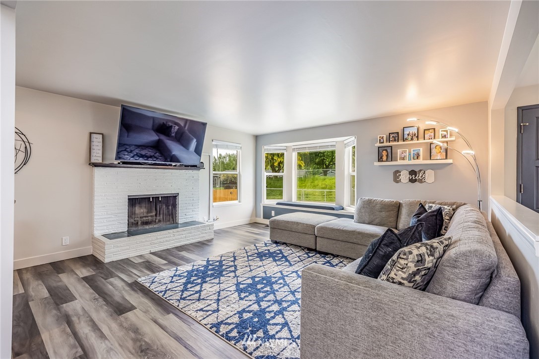 16204 Southeast 132nd Street Renton, WA 98059 - Photo 4 of 38 a living room with furniture and a fireplace