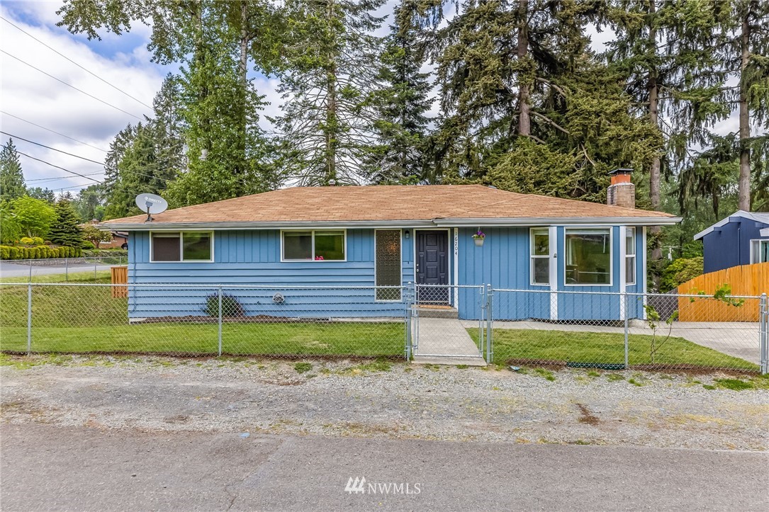 16204 Southeast 132nd Street Renton, WA 98059 - Photo 34 of 38 a front view of a house with a yard and a garage