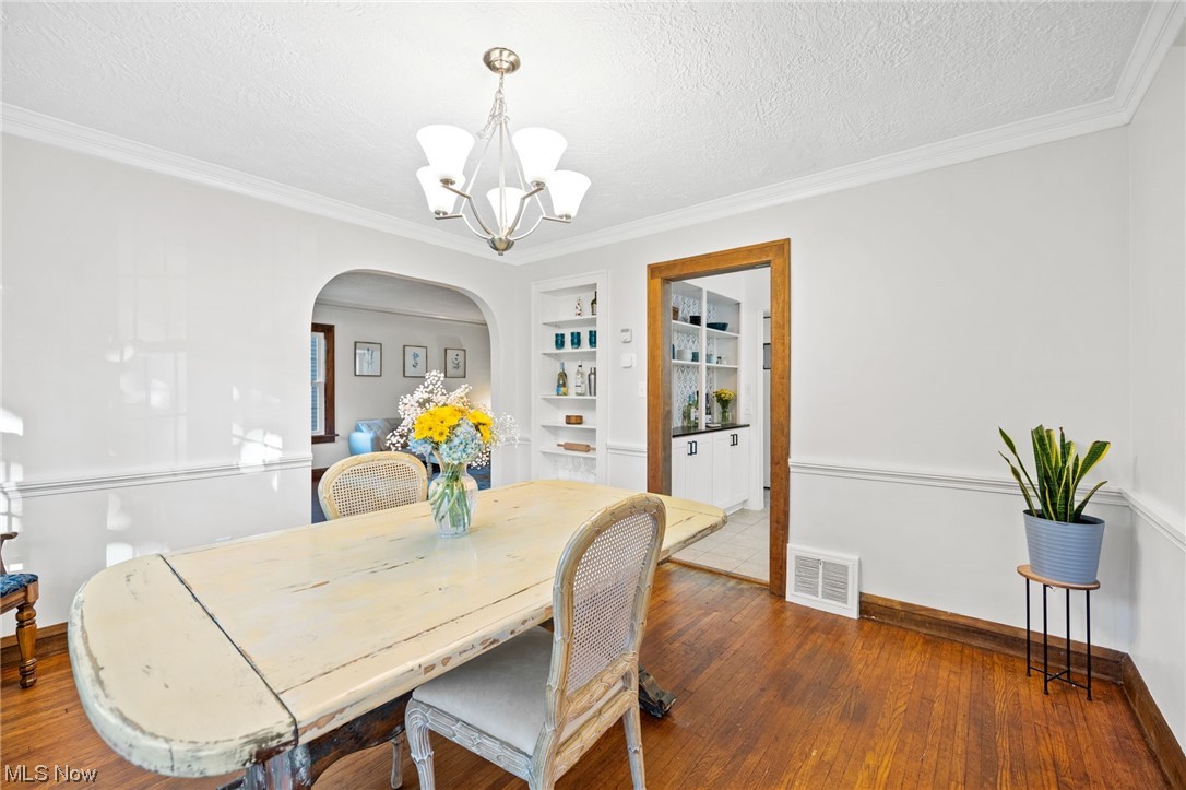 3962 Orchard Road Cleveland Heights, OH 44121 - Photo 13 of 35 Tiled dining area featuring crown molding, built in features, and a textured ceiling