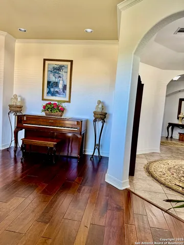 a dining room with furniture a chandelier and wooden floor