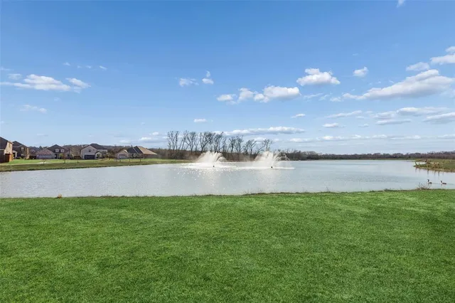 a view of a lake with houses in the back
