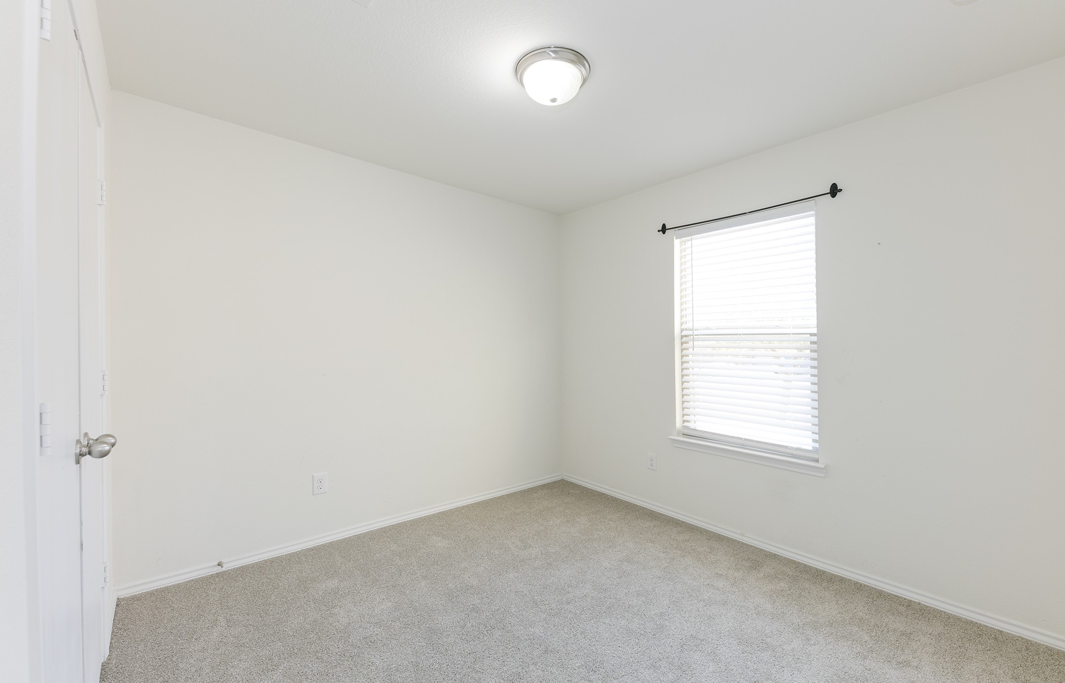 1141 Renaissance Trail Round Rock, TX 78665 - Photo 14 of 23 A well-proportioned bedroom features soft carpeting and natural light from a window with blinds.