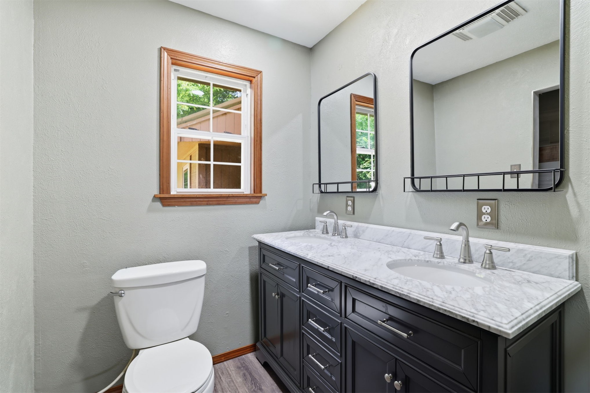 210 Main Caddo, OK 74729 - Photo 18 of 30 Double vanity with a marble-finish countertop, undermount sinks, and brushed nickel faucets