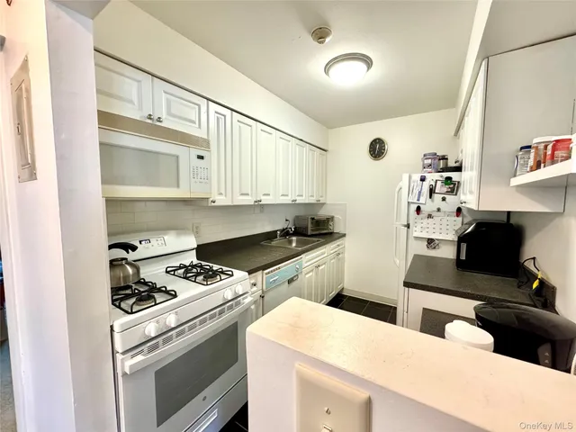 a kitchen with stainless steel appliances a stove a sink and a refrigerator