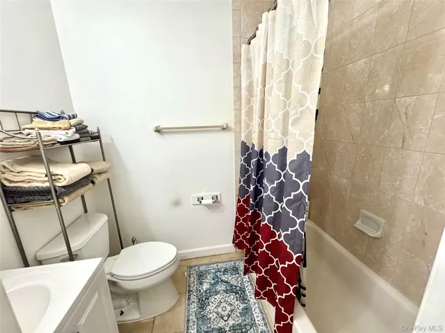 a bathroom with a toilet and shower