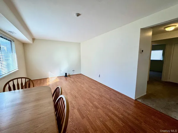 a view of a room with wooden floor