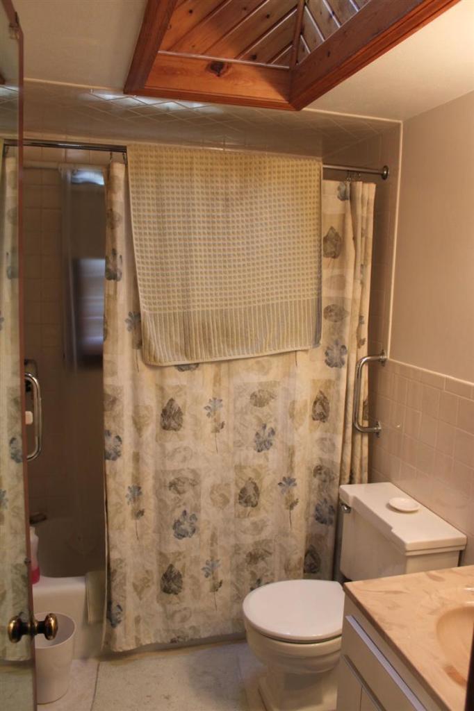 54 Route 149 Marstons Mills, MA 02648 - Photo 11 of 14 a white toilet sitting next to a shower curtain
