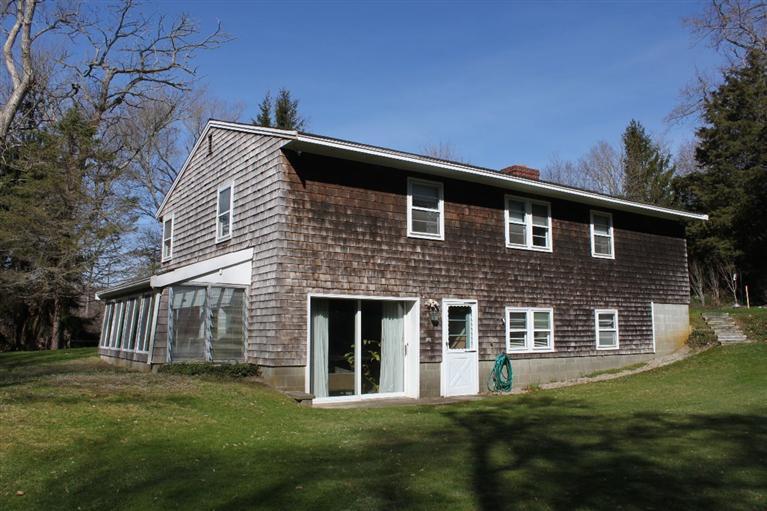 54 Route 149 Marstons Mills, MA 02648 - Photo 2 of 14 a front view of a house with a garden