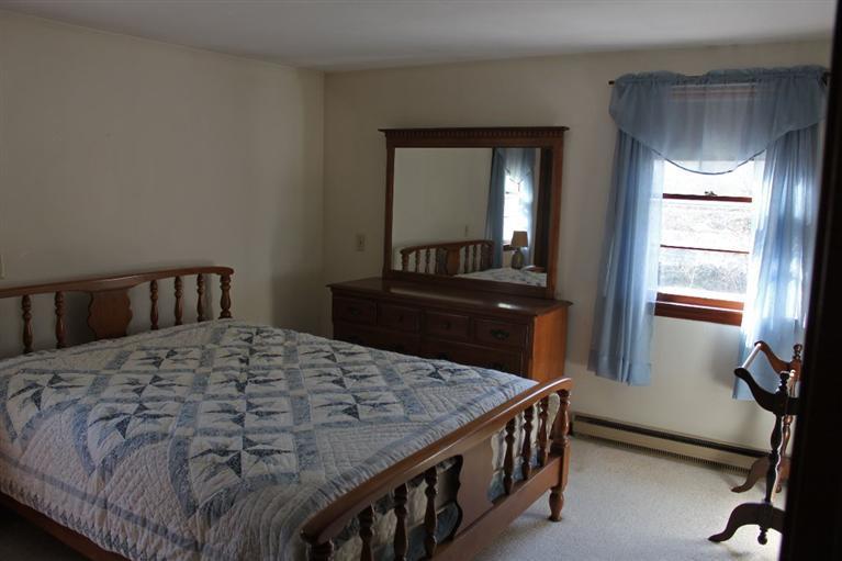 54 Route 149 Marstons Mills, MA 02648 - Photo 8 of 14 a bedroom with a bed and a dresser in it