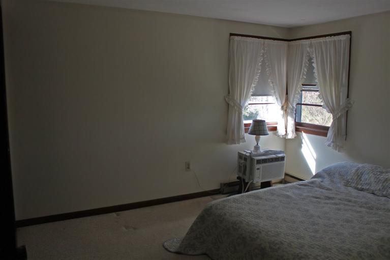 54 Route 149 Marstons Mills, MA 02648 - Photo 9 of 14 a bedroom with a bed table and chair