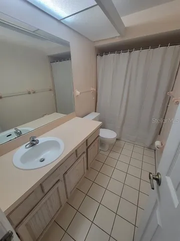 a spacious bedroom with a bed and window