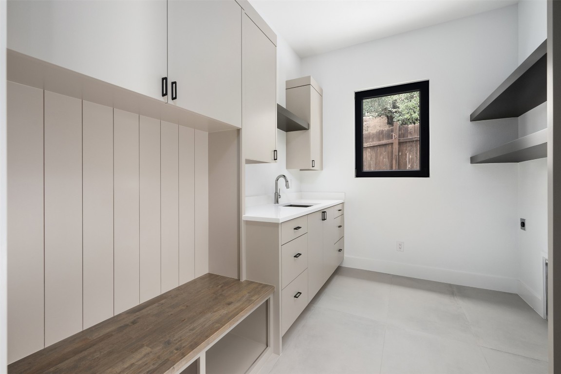 13701 A Montview Drive Austin, TX 78732 - Photo 16 of 40 Mud room/laundry room with bench cubbies, cabinets, sink and space for refrigerator.