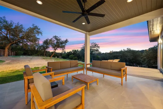 a view of a patio with a table chairs and a swimming pool
