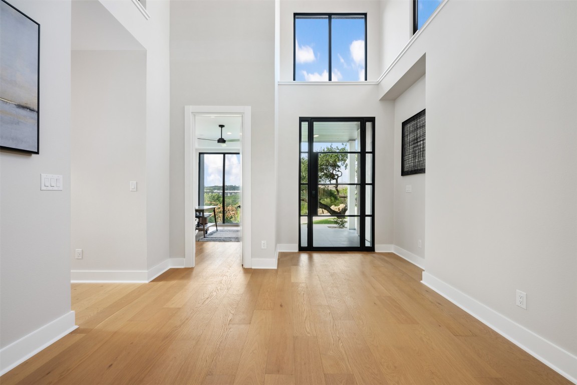 13701 A Montview Drive Austin, TX 78732 - Photo 7 of 40 White Oak Flooring and Iron and Glass door welcome you in.