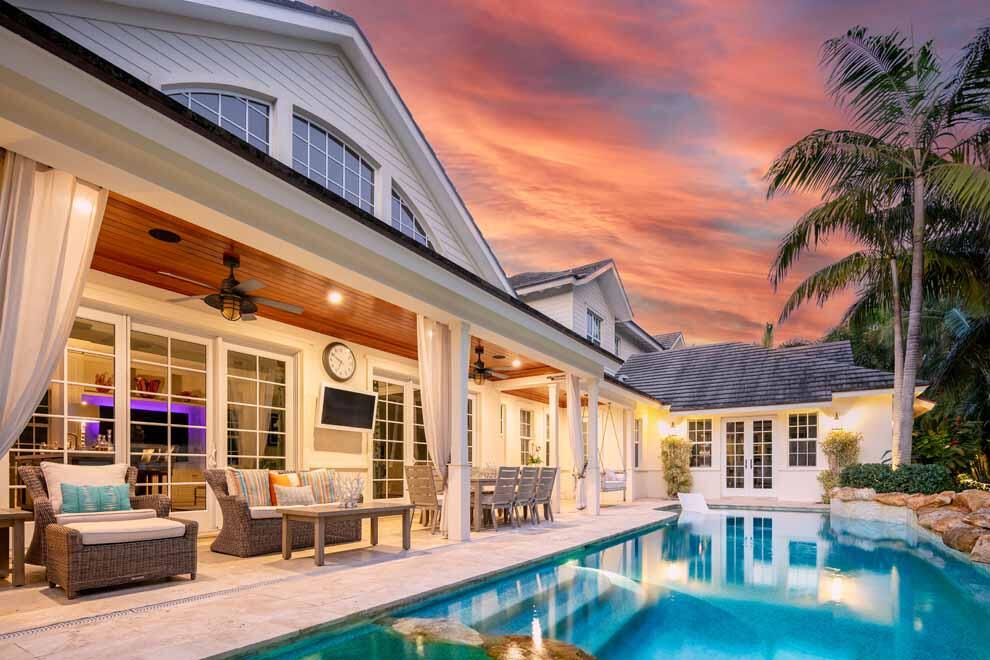 a view of a building with a large window and potted plants