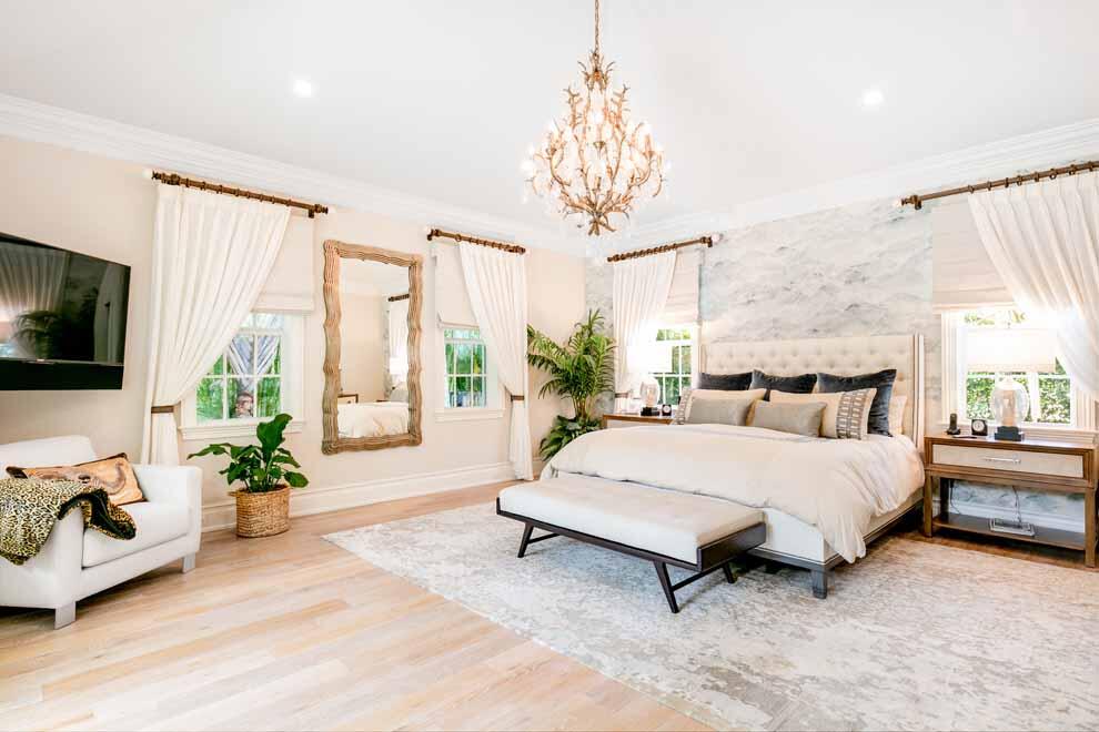 1230 North Ocean Boulevard Gulf Stream, FL 33483 - Photo 18 of 53 a spacious bedroom with a bed a flat screen tv and a large window